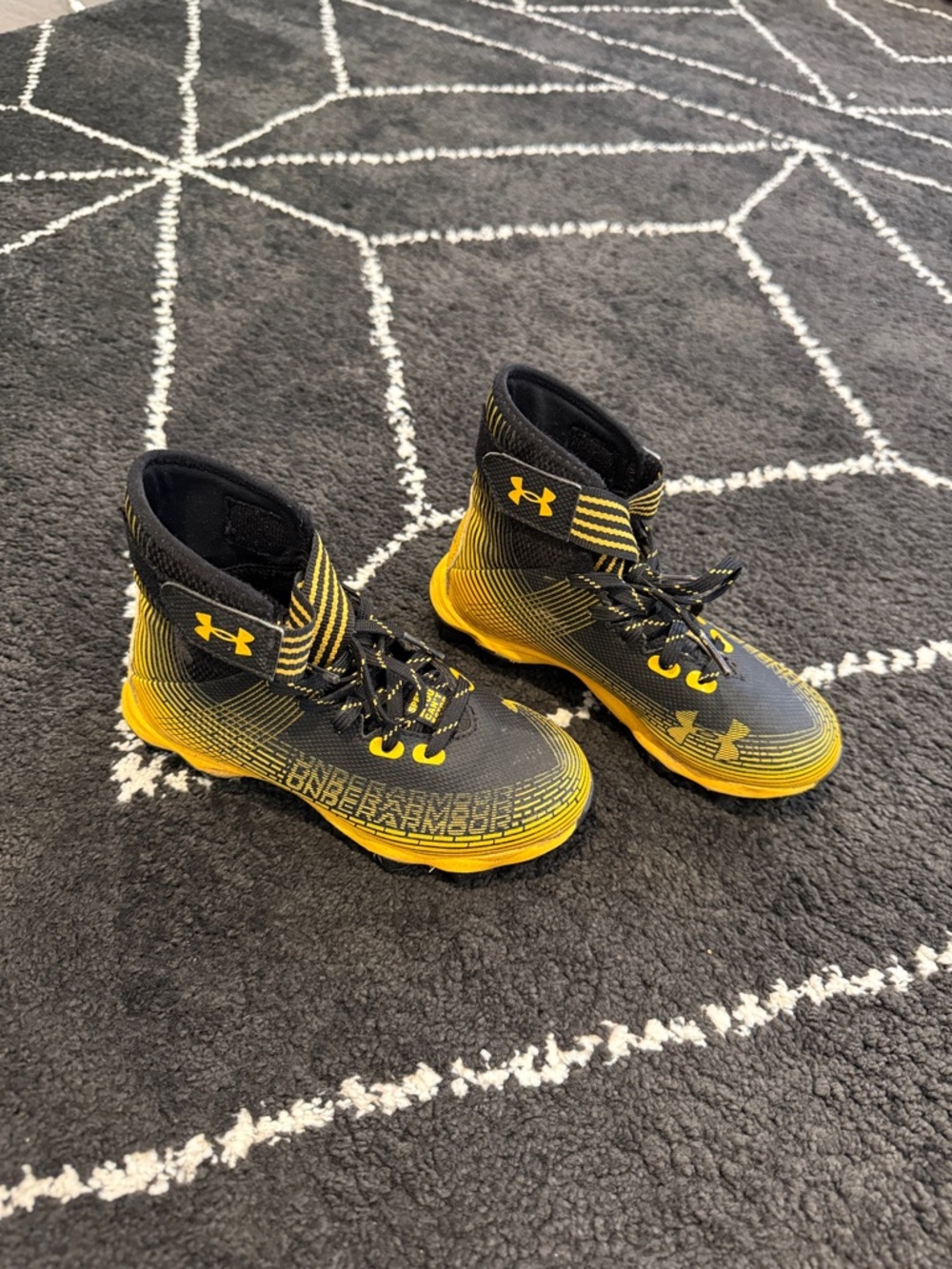 Under Armour little kids Black and Yellow football cleats